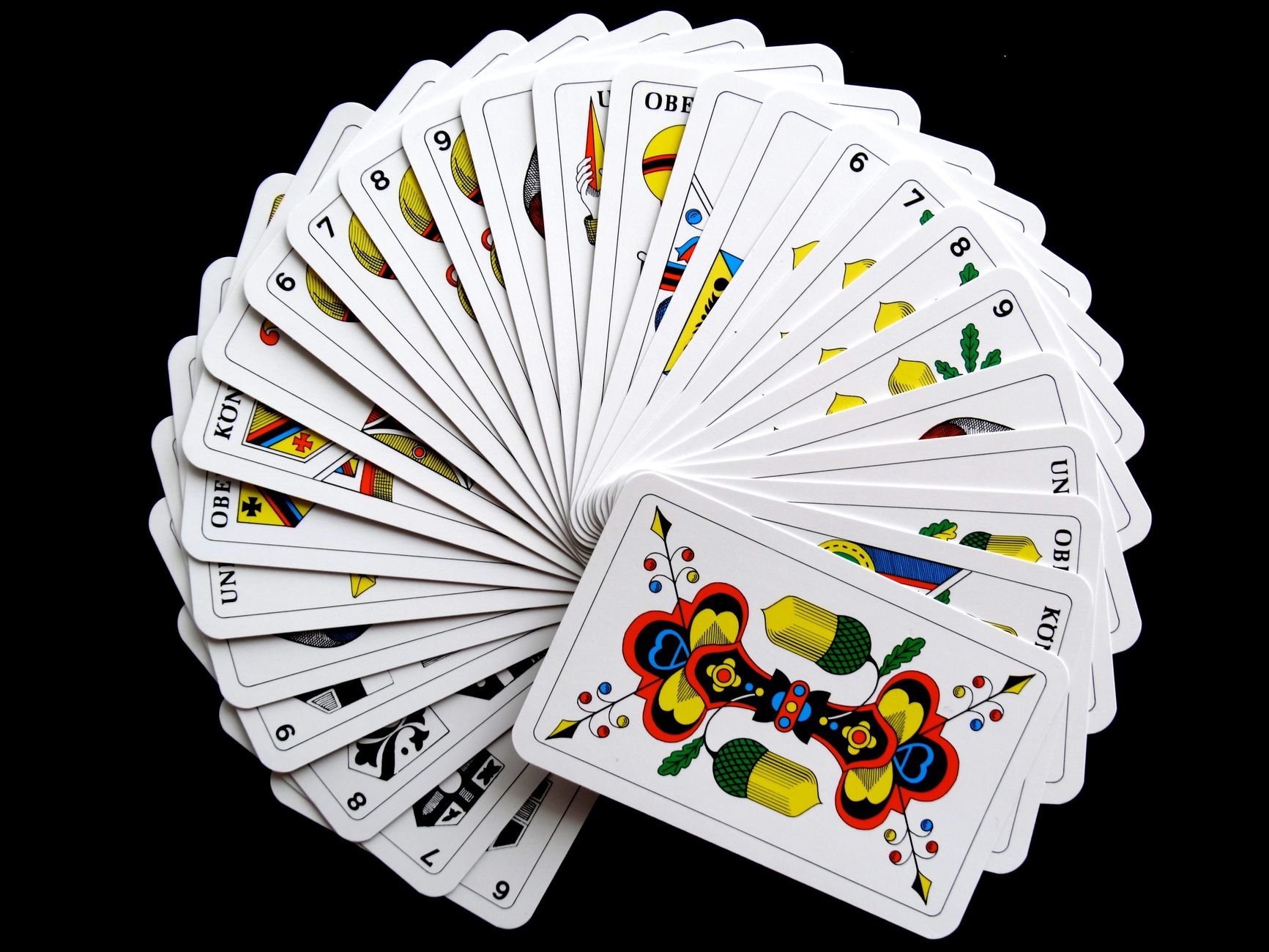 Vibrant playing cards fanned out against a dark background